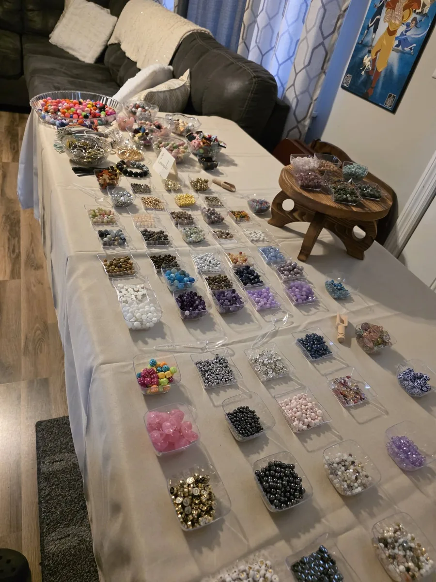 Bead trays set out across a workshop table