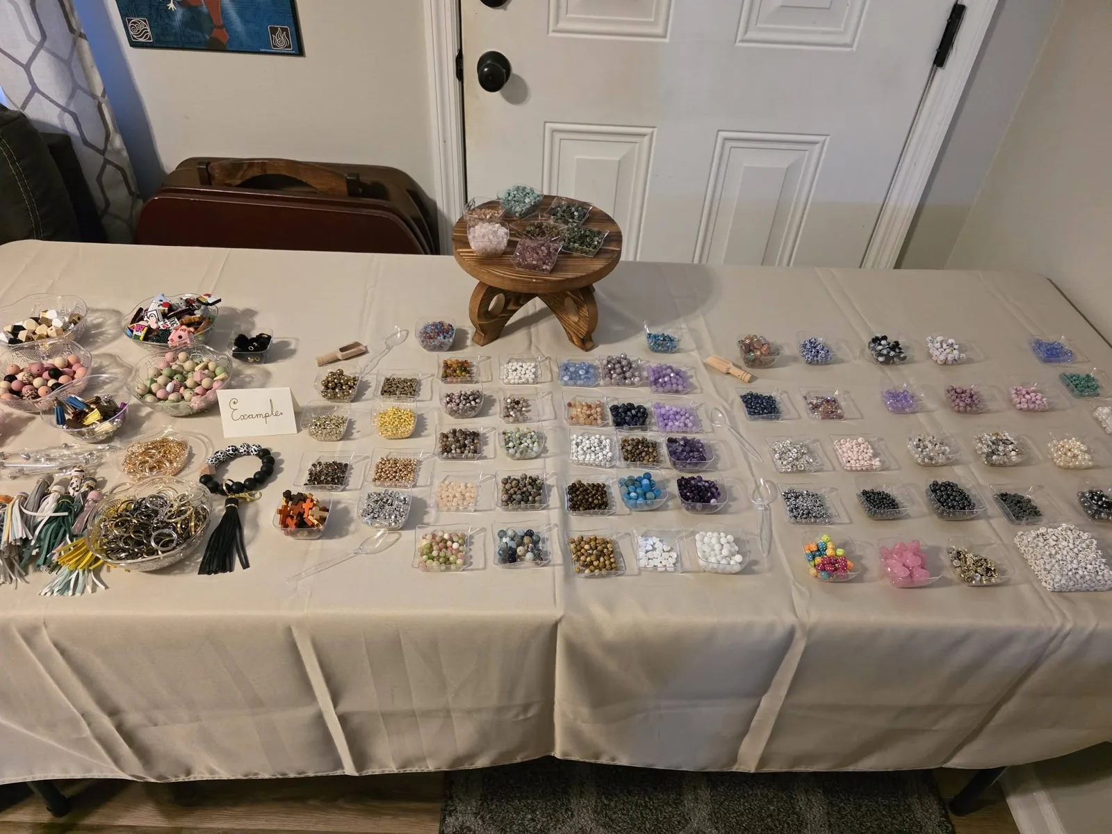 A long workshop table set with bowls of beads